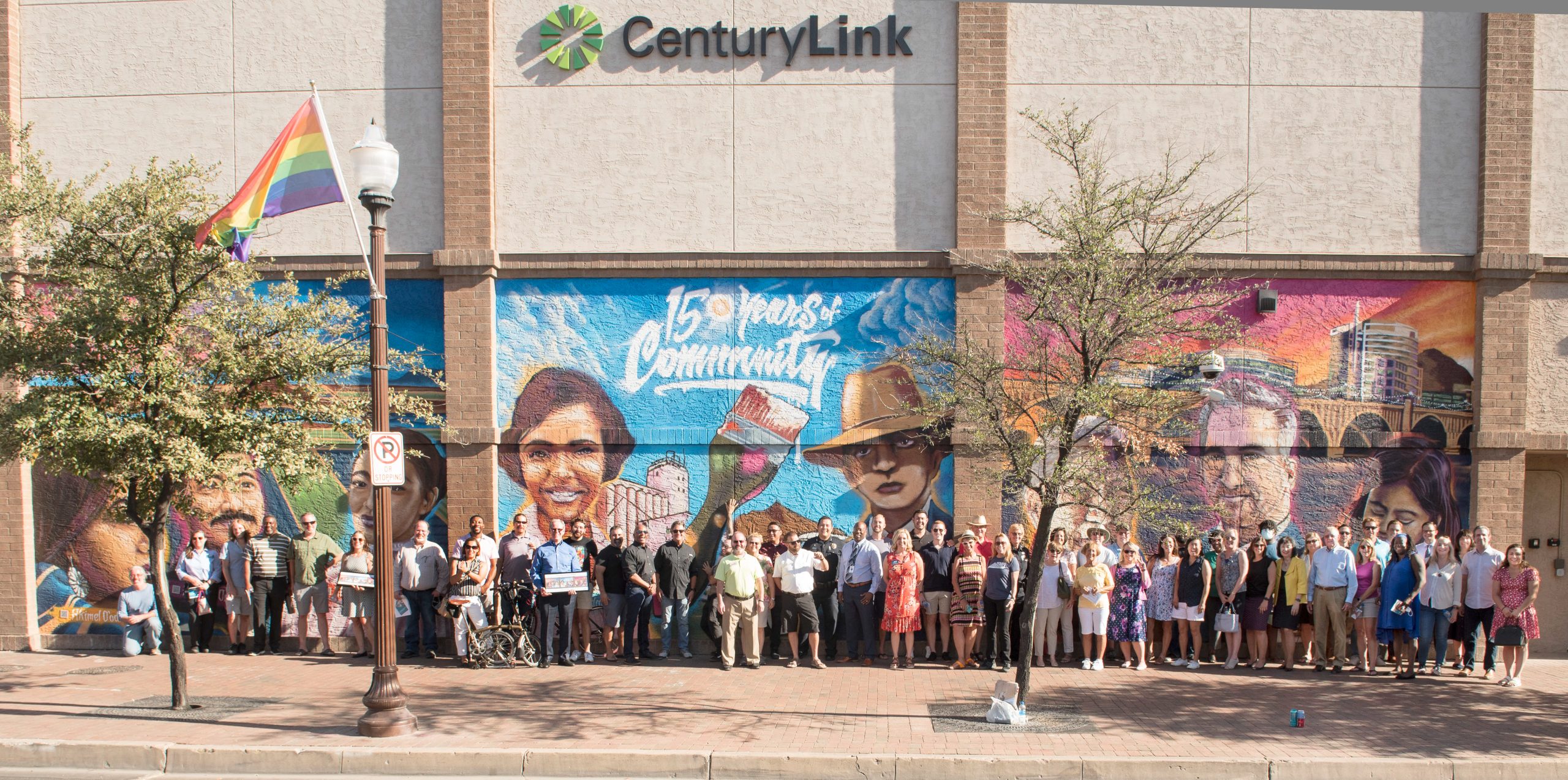 Large group of people in front of mural